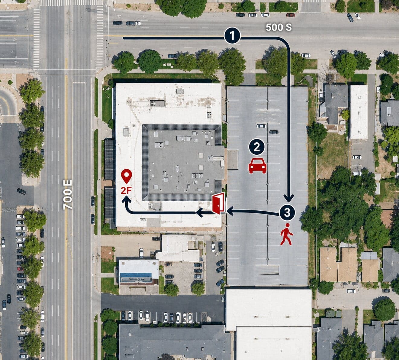 Aerial photo of Trolley Corner, marked with the route in: turn south off 500 South into the building's parking, park in the deck along its east side, then walk west to the entrance in the middle of that face. From there the route continues around the south side of the building to a pin marking Suite 2F, on the 700 East side.